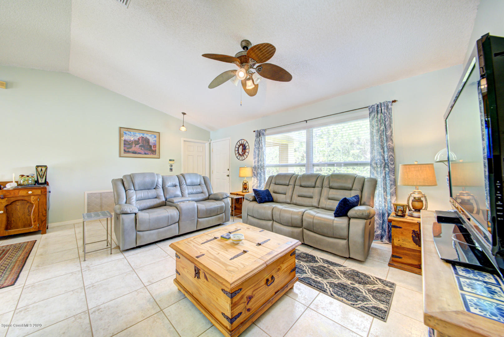 984 Ray Road Southeast Palm Bay, FL 32909 - Photo 14 of 45 a living room with furniture a rug and a large window