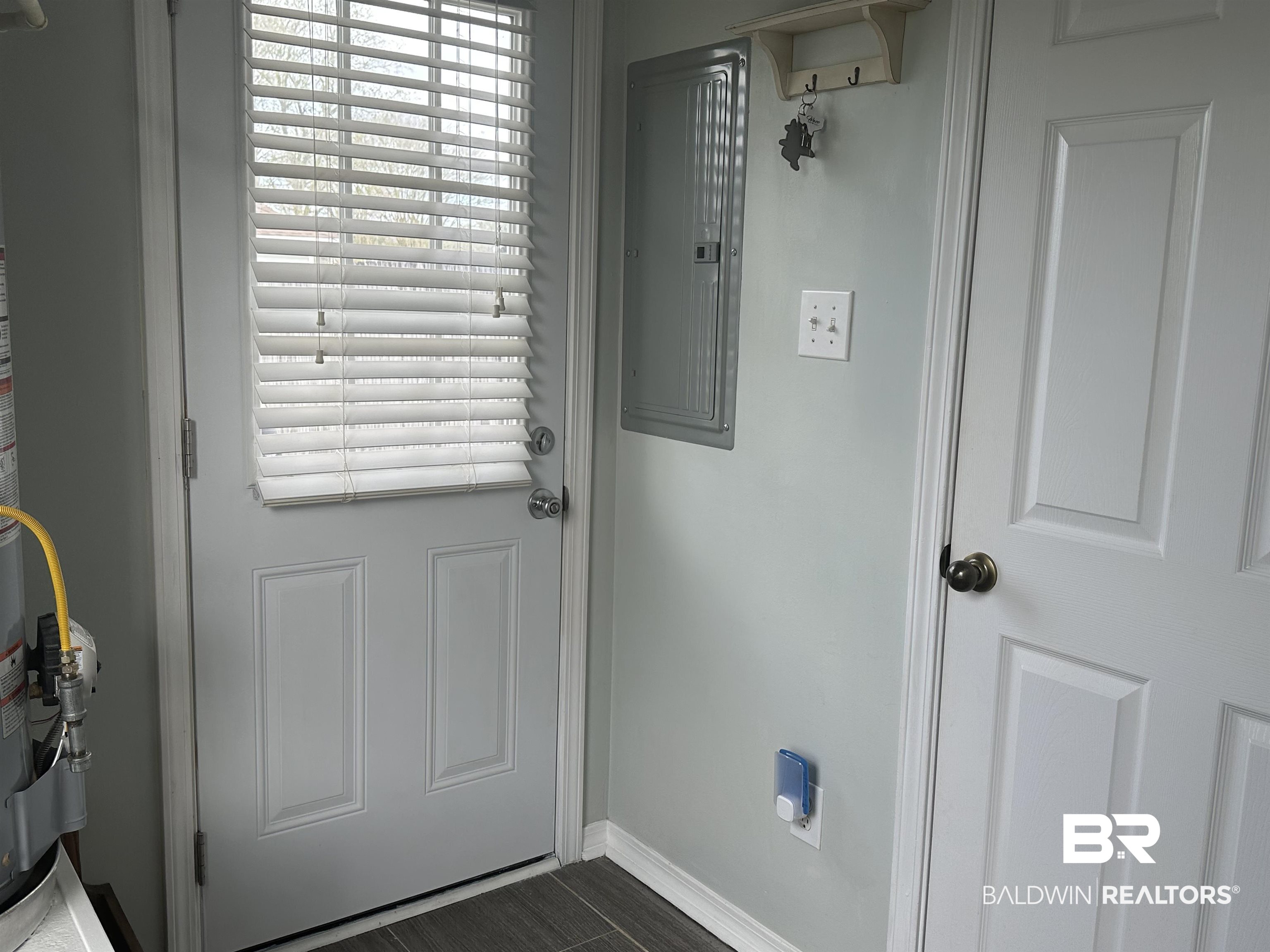 4882 Rebecca Place Mobile, AL 36695 - Photo 6 of 29 Doorway to outside featuring electric panel and baseboards