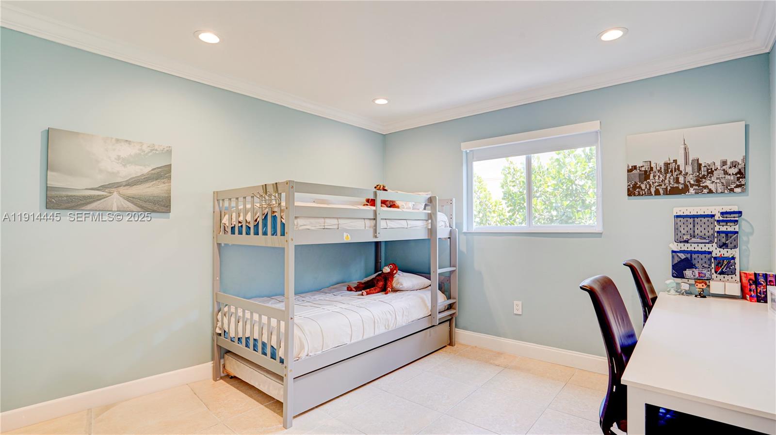 9573 Southwest 57th Street Miami, FL 33173 - Photo 14 of 34 a bed room with a bed and a chair