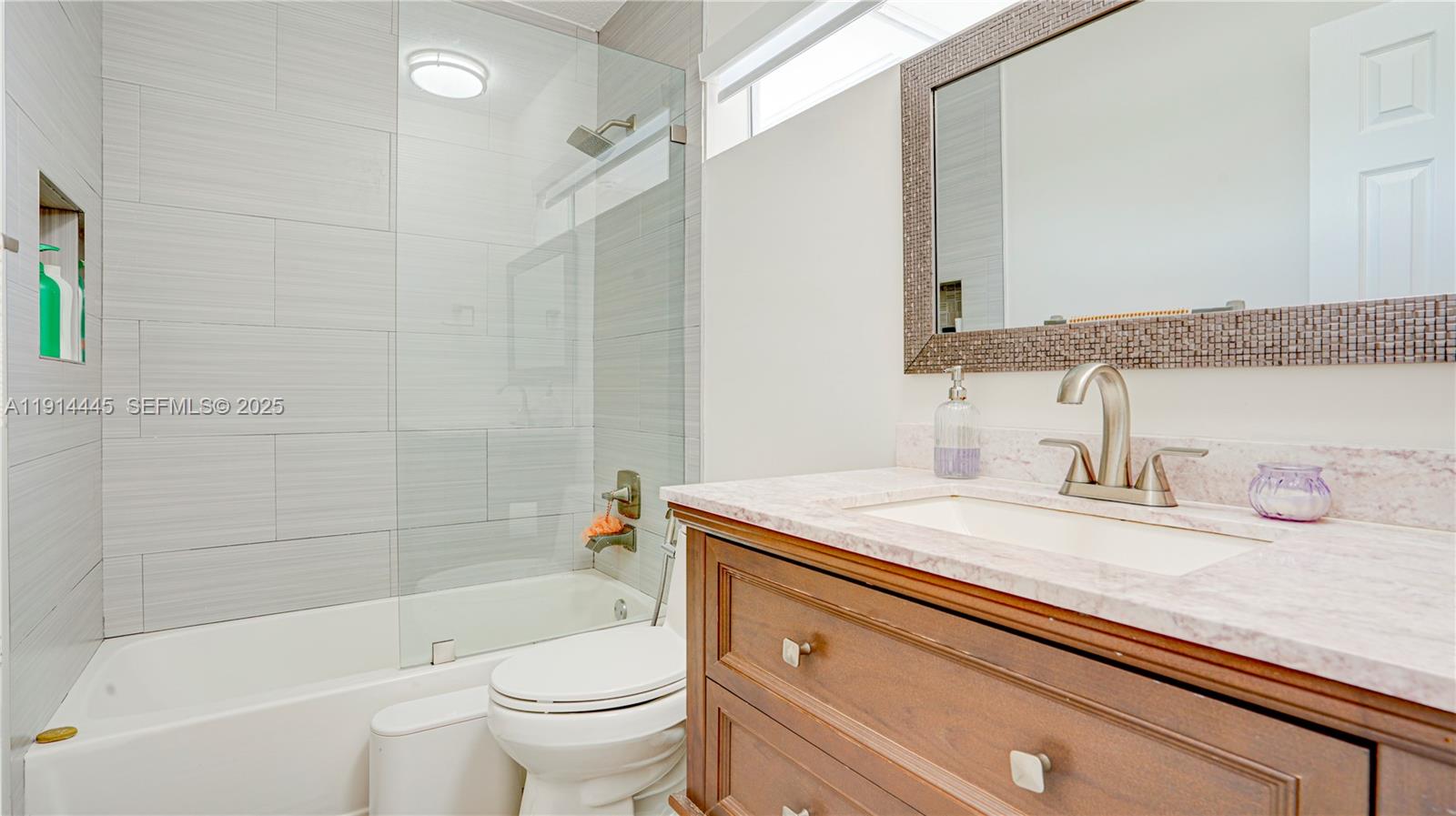 9573 Southwest 57th Street Miami, FL 33173 - Photo 16 of 34 a bathroom with a sink a toilet and a bathtub