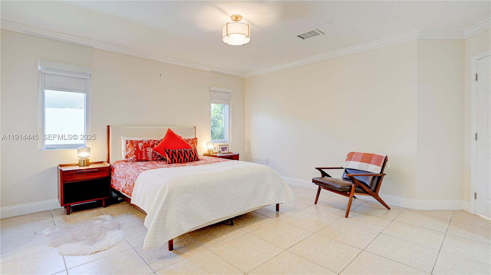 9573 Southwest 57th Street Miami, FL 33173 - Photo 18 of 34 a bedroom with a bed and a window