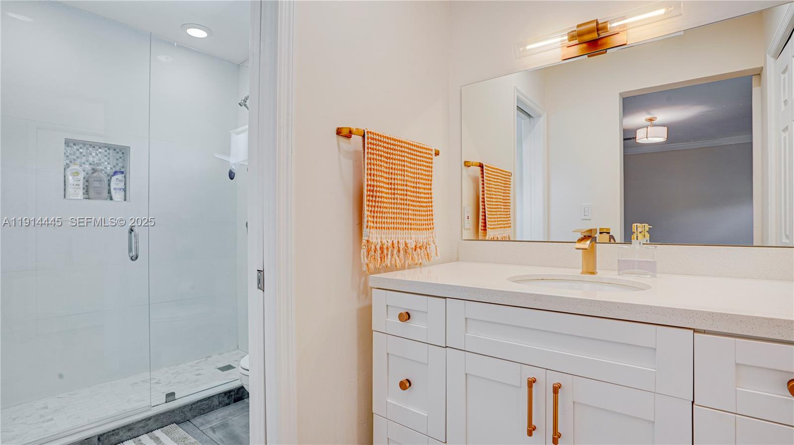9573 Southwest 57th Street Miami, FL 33173 - Photo 20 of 34 a bathroom with a sink and a mirror