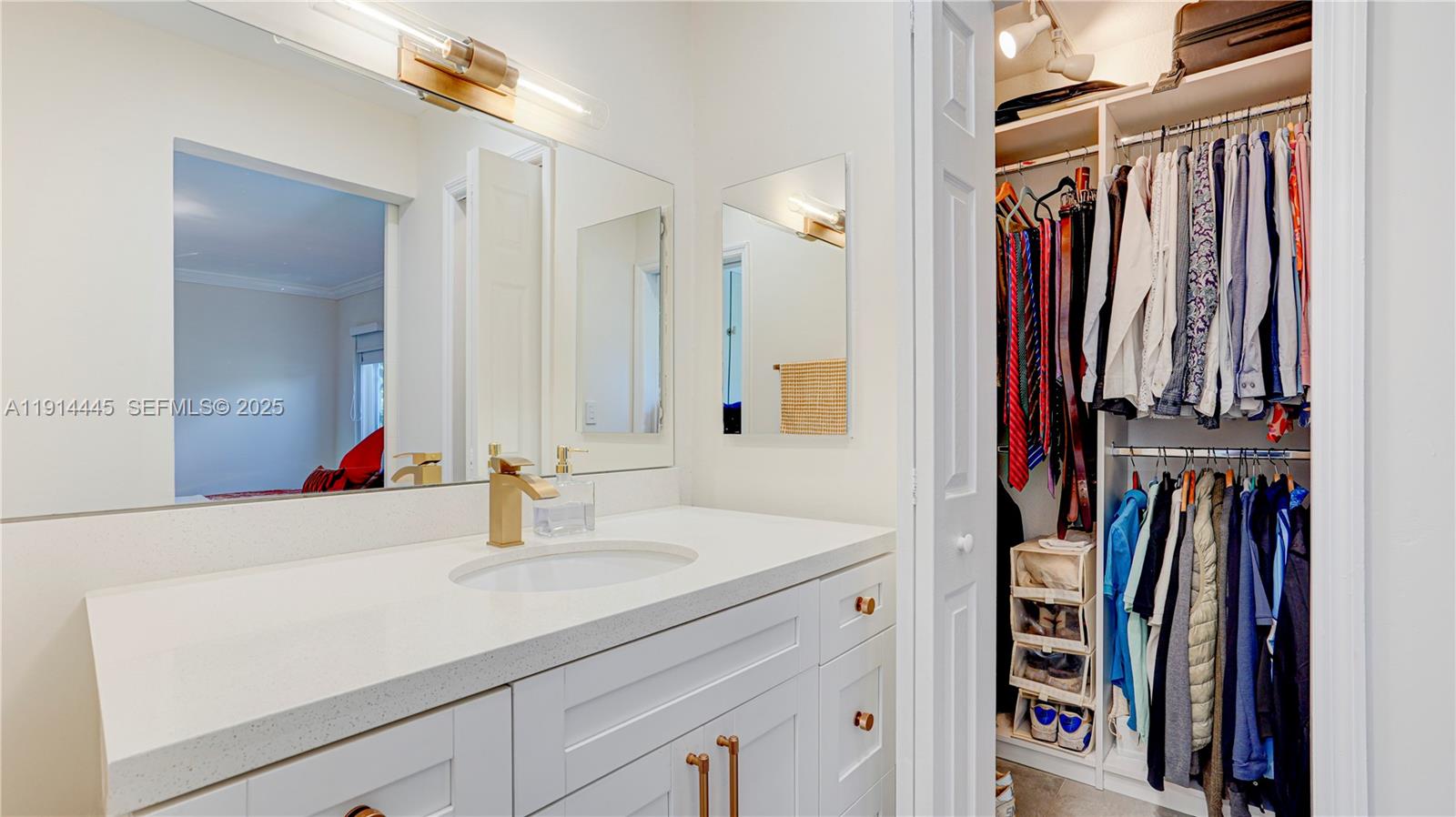 9573 Southwest 57th Street Miami, FL 33173 - Photo 22 of 34 a bathroom with a sink and a mirror