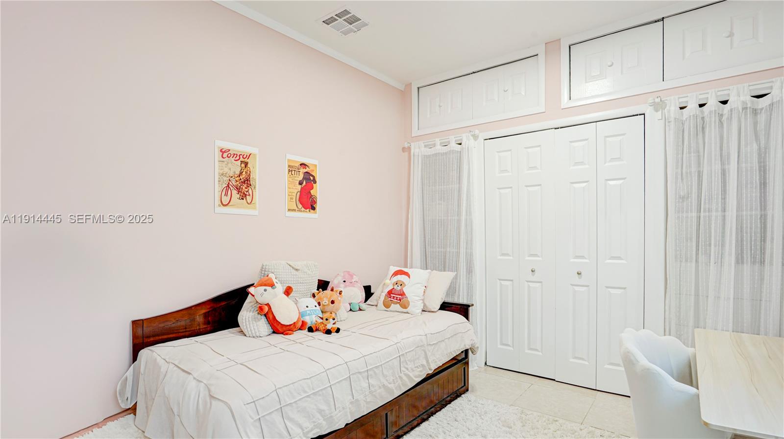 9573 Southwest 57th Street Miami, FL 33173 - Photo 26 of 34 a bedroom with a bed and a table