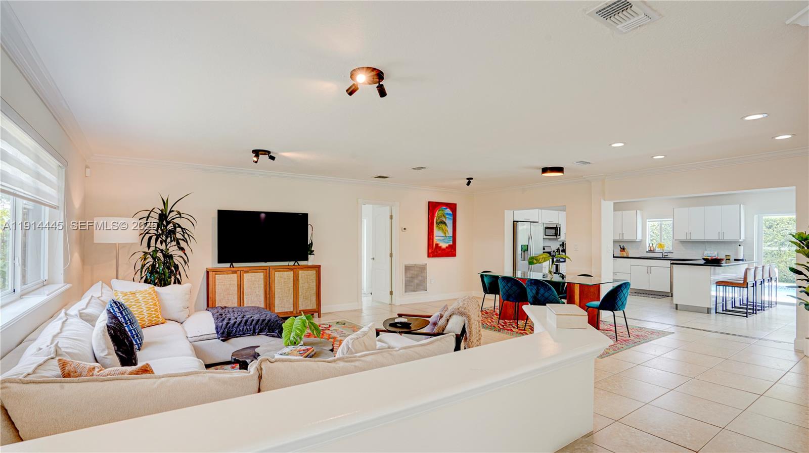 9573 Southwest 57th Street Miami, FL 33173 - Photo 4 of 34 a living room with furniture and a flat screen tv
