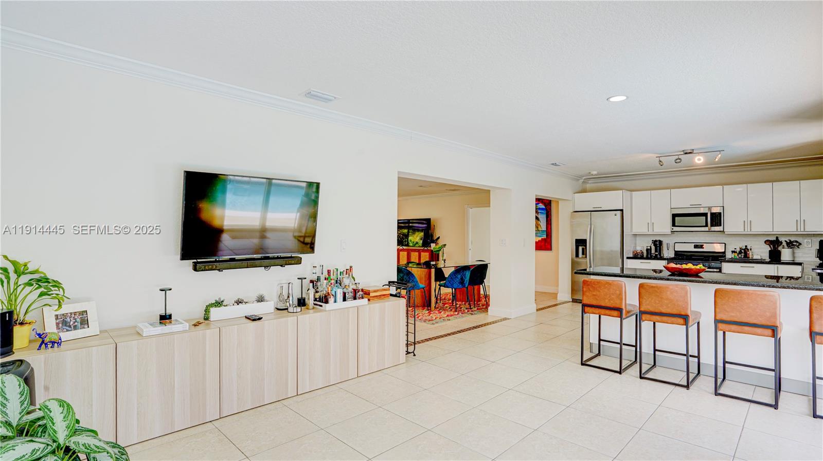 9573 Southwest 57th Street Miami, FL 33173 - Photo 10 of 34 a living room with furniture and a flat screen tv