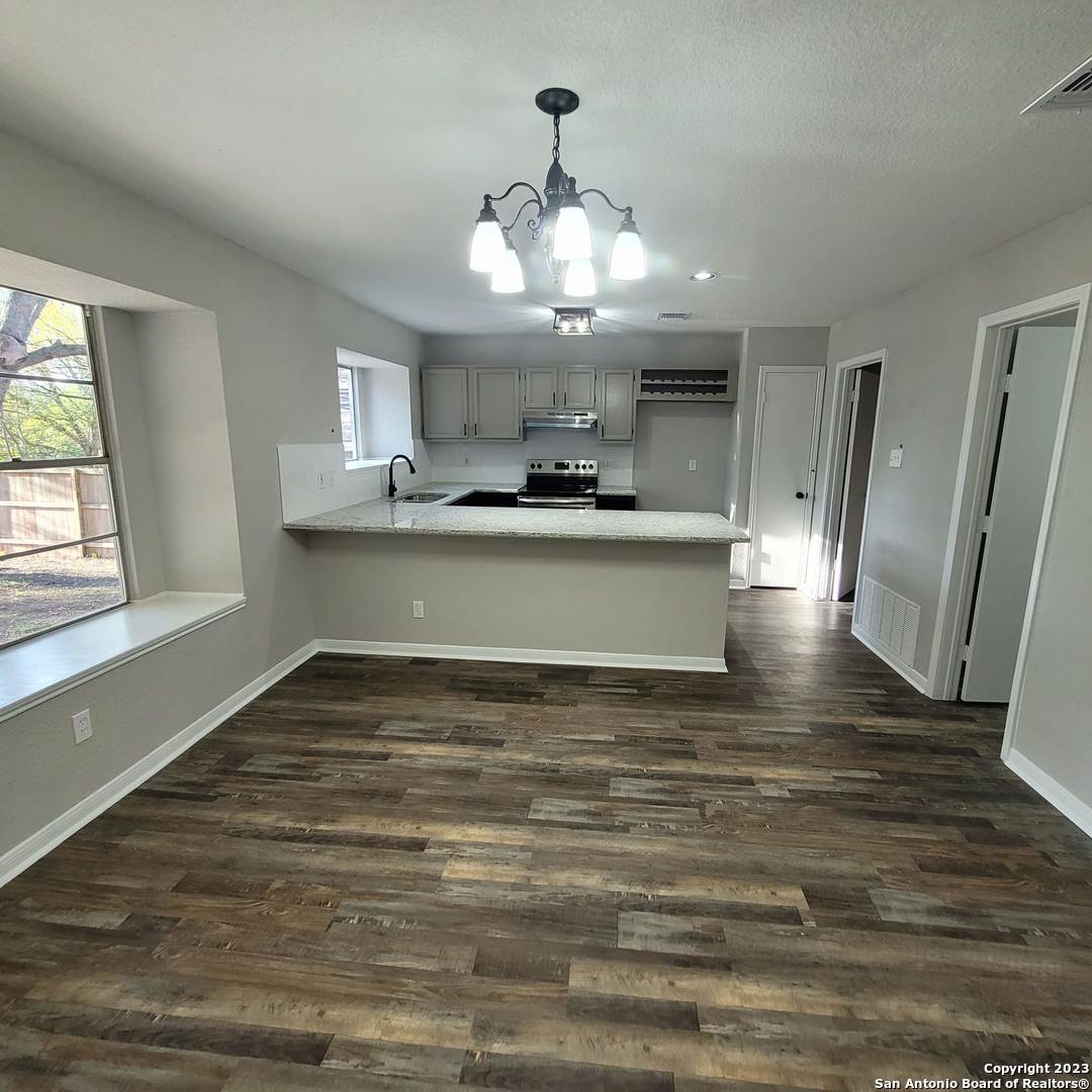 14623 Highland Ridge San Antonio, TX 78233 - Photo 12 of 37 a view of a kitchen with cabinets and wooden floor