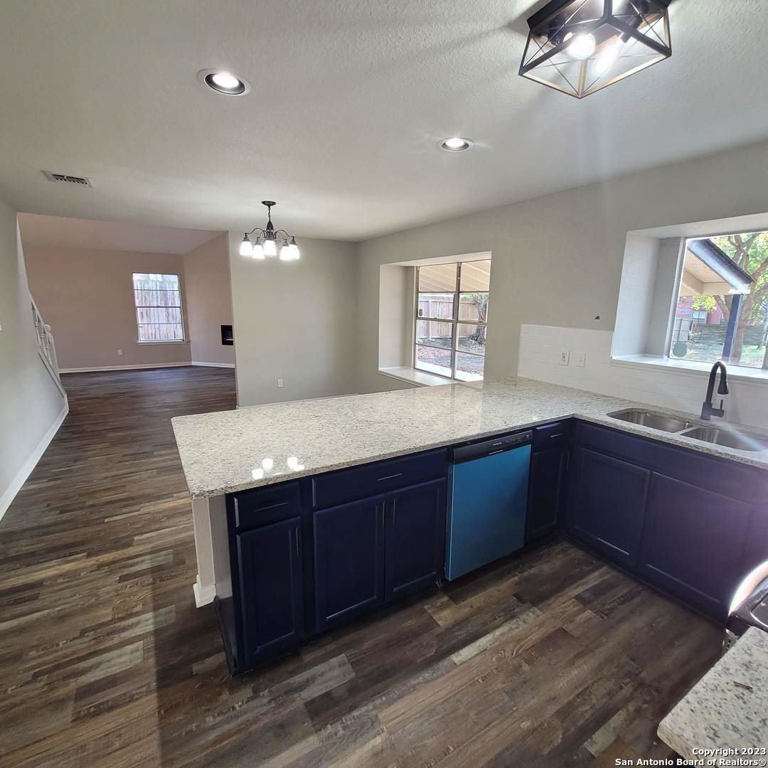 14623 Highland Ridge San Antonio, TX 78233 - Photo 14 of 37 a kitchen with granite countertop a sink and a stove