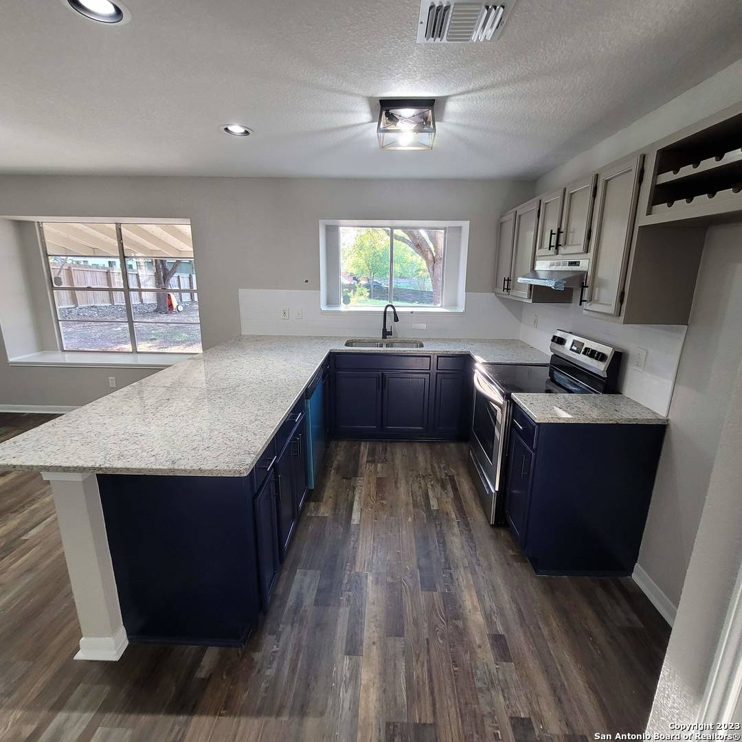 14623 Highland Ridge San Antonio, TX 78233 - Photo 16 of 37 a kitchen with counter top space and wooden floor