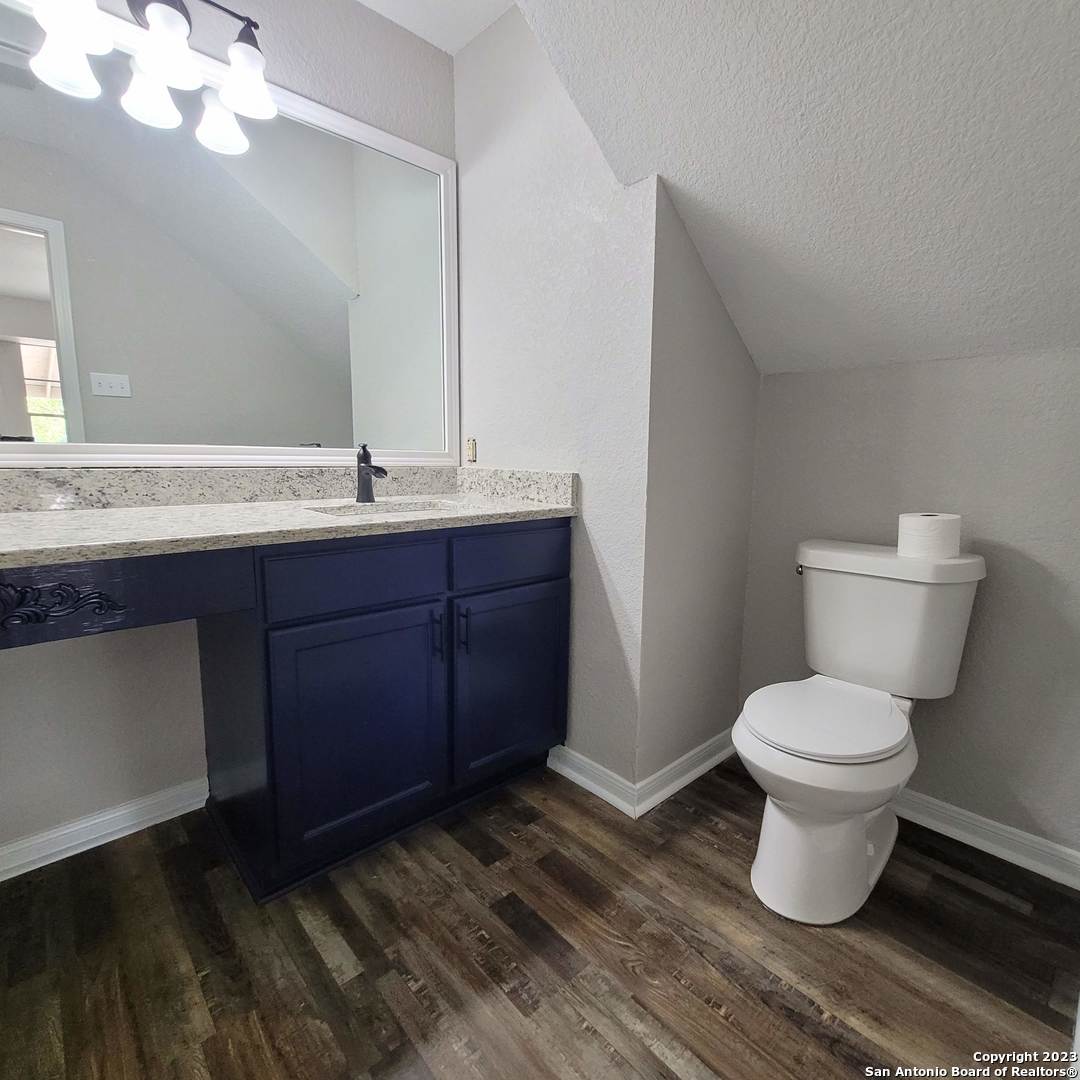 14623 Highland Ridge San Antonio, TX 78233 - Photo 19 of 37 a bathroom with a toilet sink and mirror