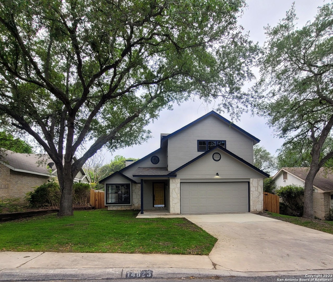14623 Highland Ridge San Antonio, TX 78233 - Photo 2 of 37 a front view of a house with a garden and trees