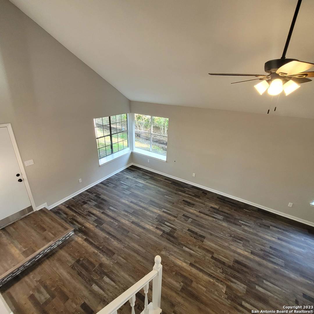 14623 Highland Ridge San Antonio, TX 78233 - Photo 21 of 37 a view of empty room with wooden floor and fan