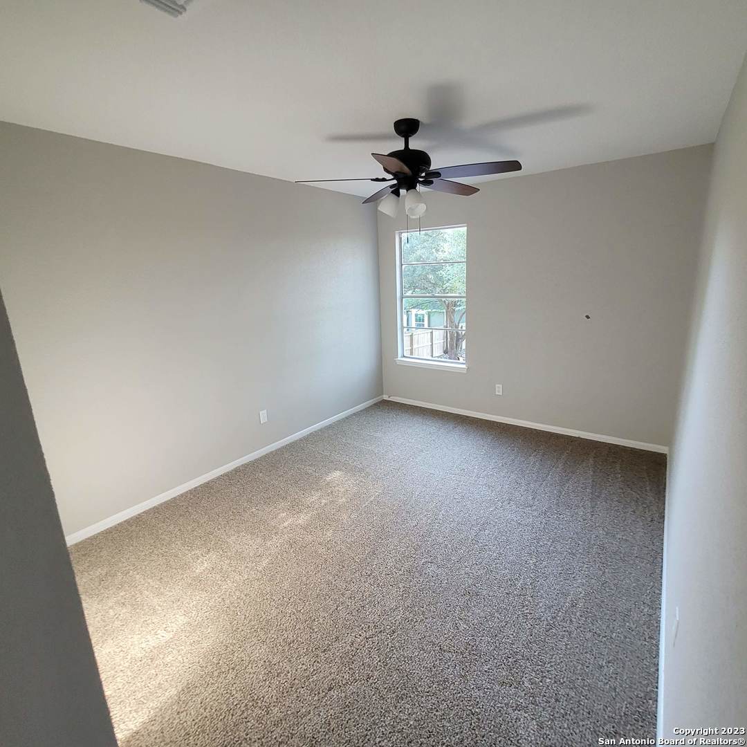 14623 Highland Ridge San Antonio, TX 78233 - Photo 23 of 37 an empty room with windows and fan