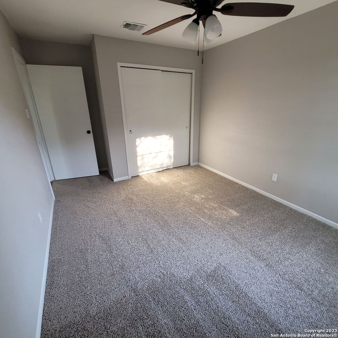14623 Highland Ridge San Antonio, TX 78233 - Photo 24 of 37 a view of a room with a ceiling fan and a rug