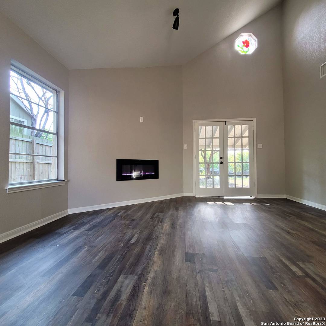 14623 Highland Ridge San Antonio, TX 78233 - Photo 9 of 37 an empty room with wooden floor and windows