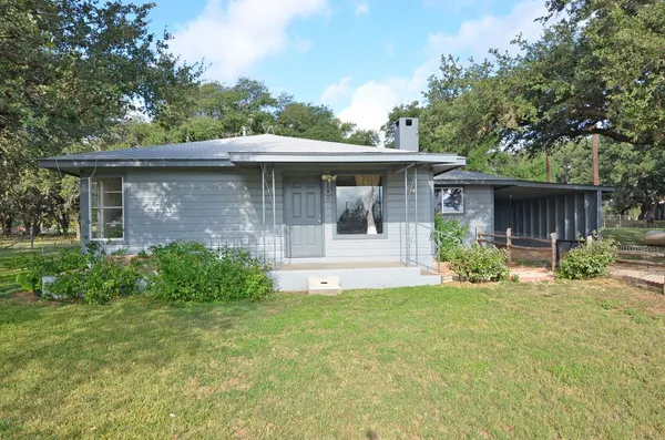 a front view of a house with a yard and porch