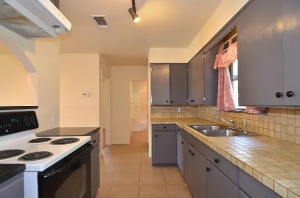 a kitchen with a stove and a sink