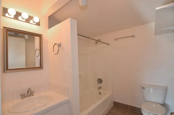 a bathroom with a sink mirror vanity and toilet