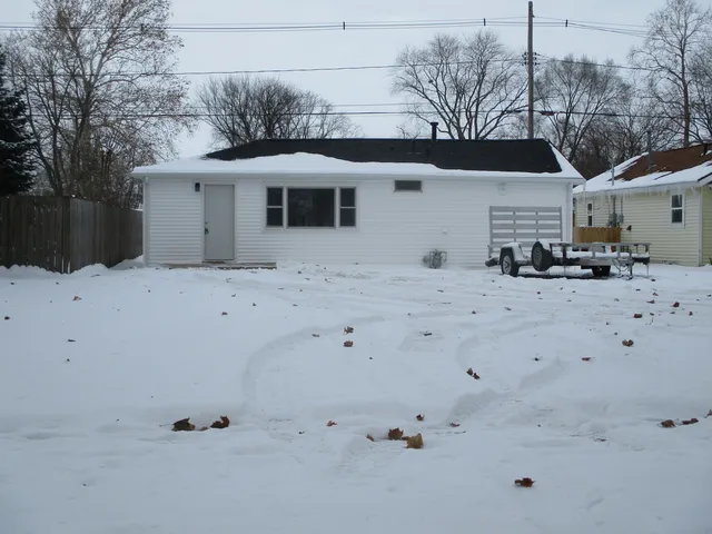 a view of white house with a snow in the background