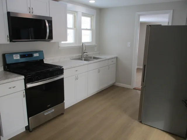 a kitchen with a sink stove and microwave