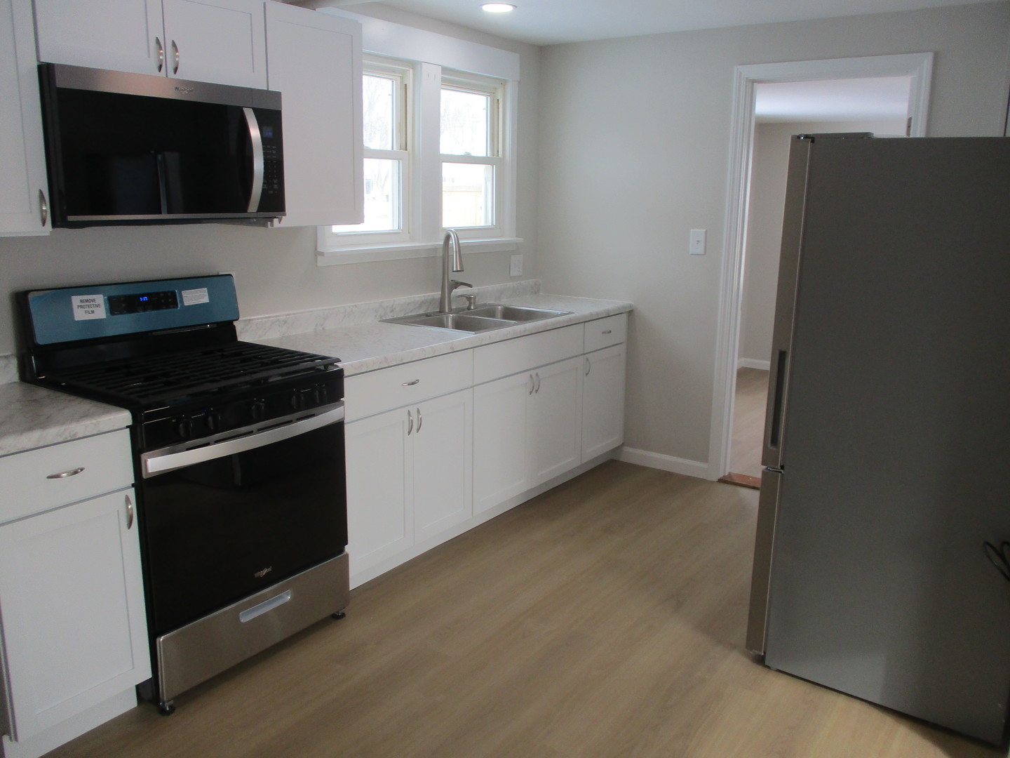 918 West Vine Street Champaign, IL 61821 - Photo 4 of 14 a kitchen with a sink stove and microwave