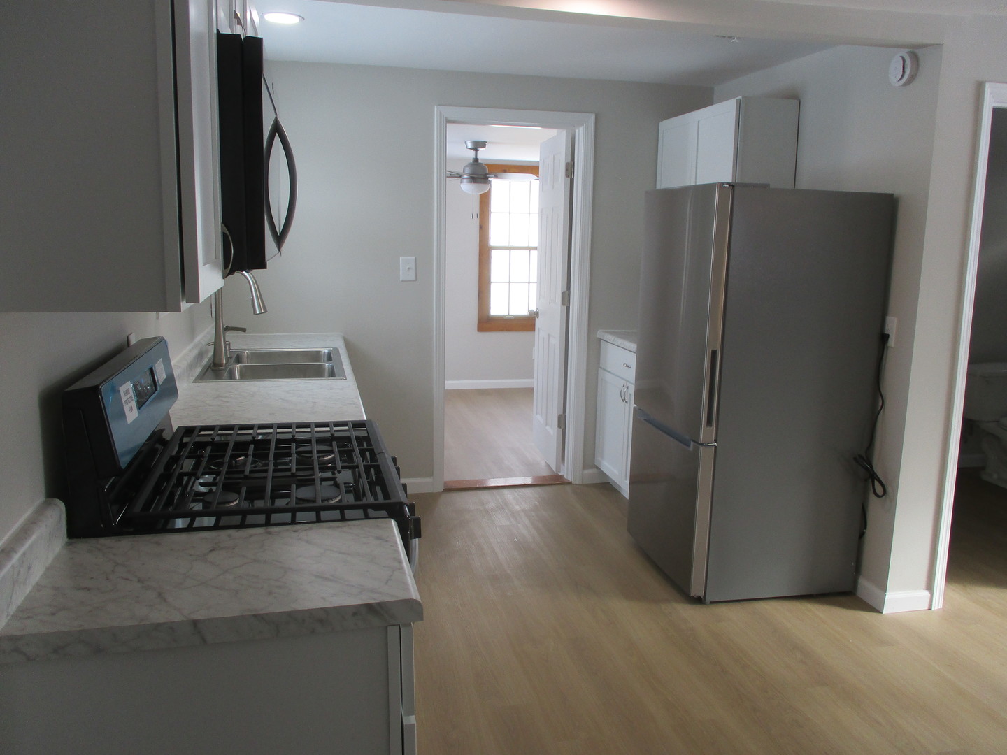 918 West Vine Street Champaign, IL 61821 - Photo 5 of 14 a kitchen with granite countertop a refrigerator and a stove top oven