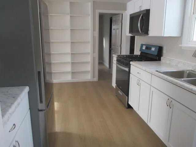 a kitchen with a refrigerator and a sink