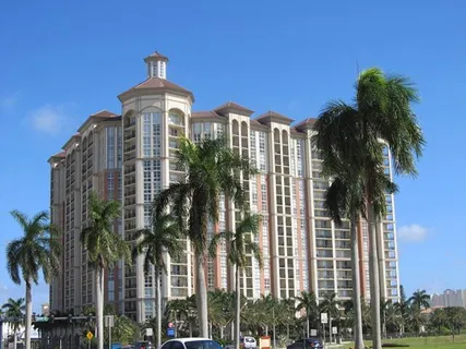 a front view of a residential apartment building with a yard