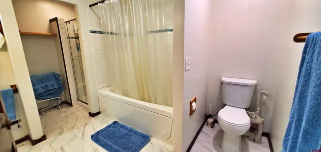 an empty room with chandelier fan