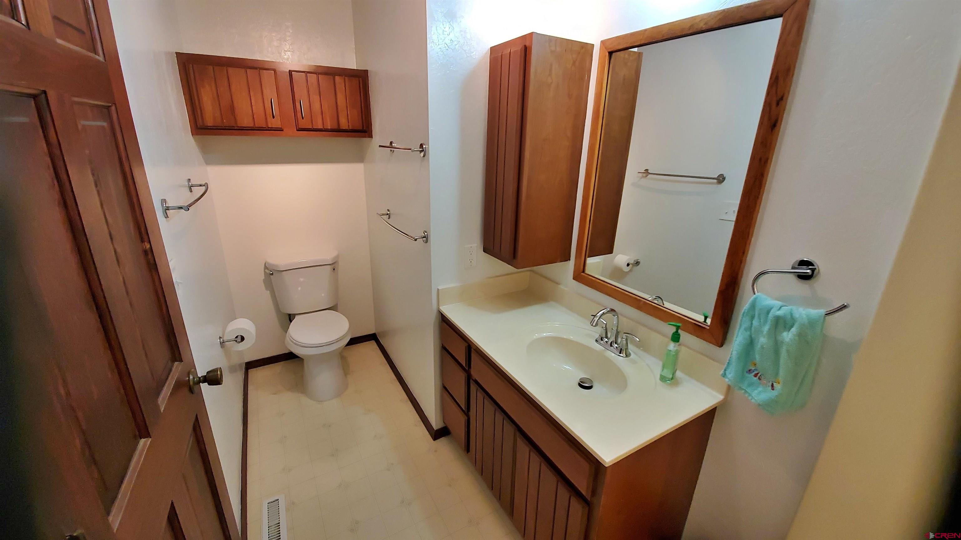 22250 County Rd M Cortez, CO 81321 - Photo 21 of 45 a bathroom with a sink a mirror and a toilet
