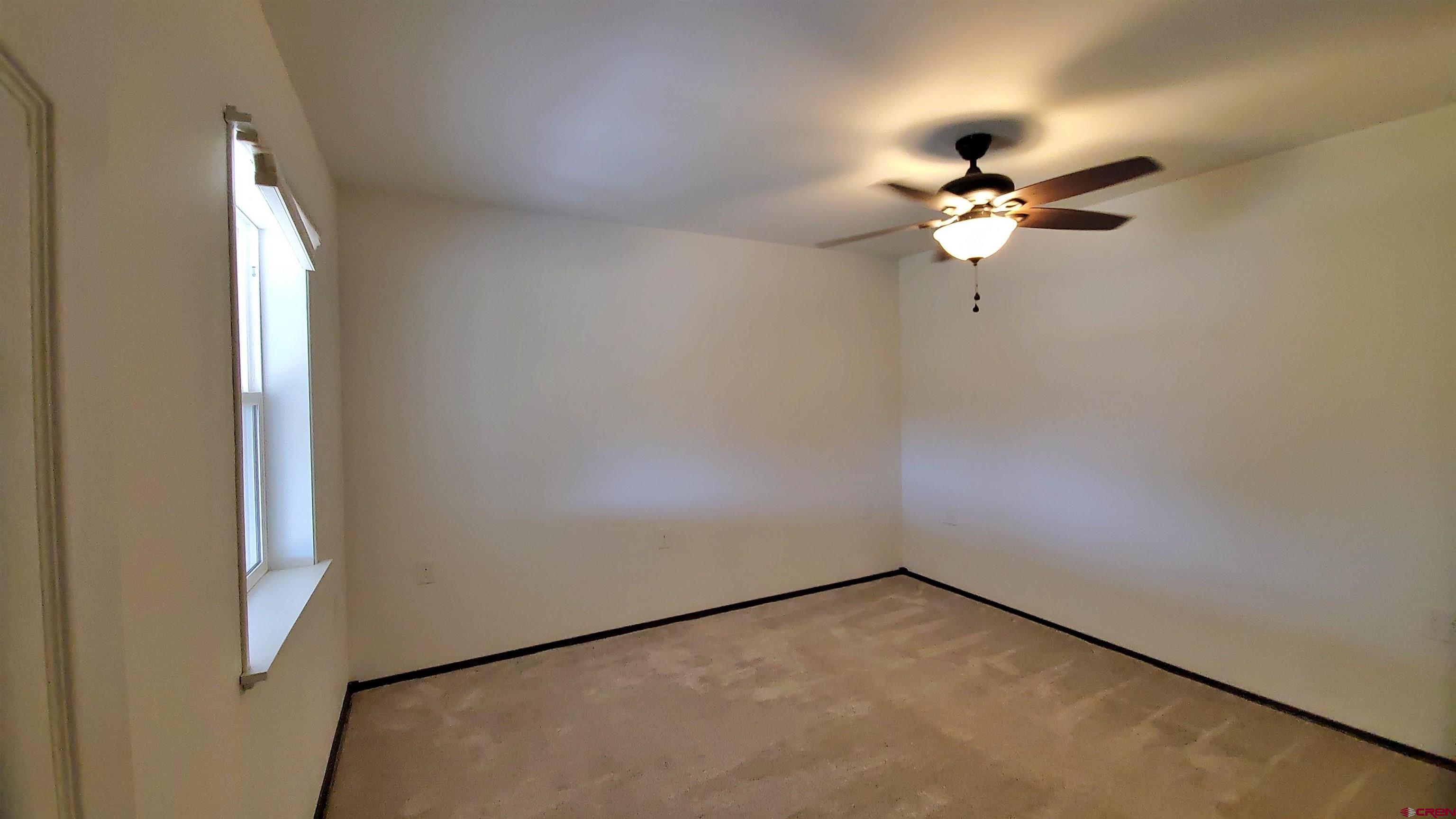 22250 County Rd M Cortez, CO 81321 - Photo 22 of 45 an empty room with a window and a fan