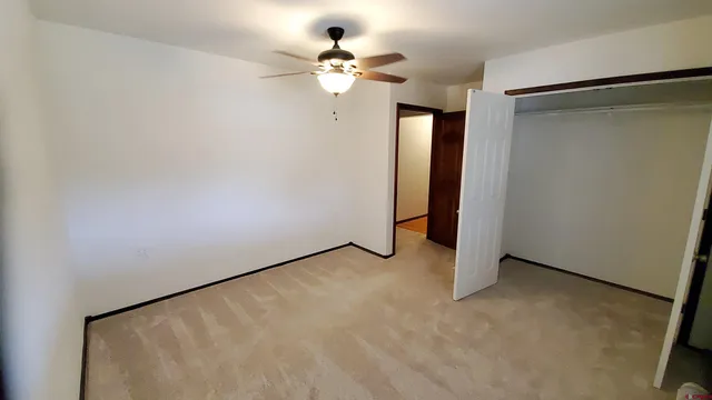 a view of walk in closet with empty racks