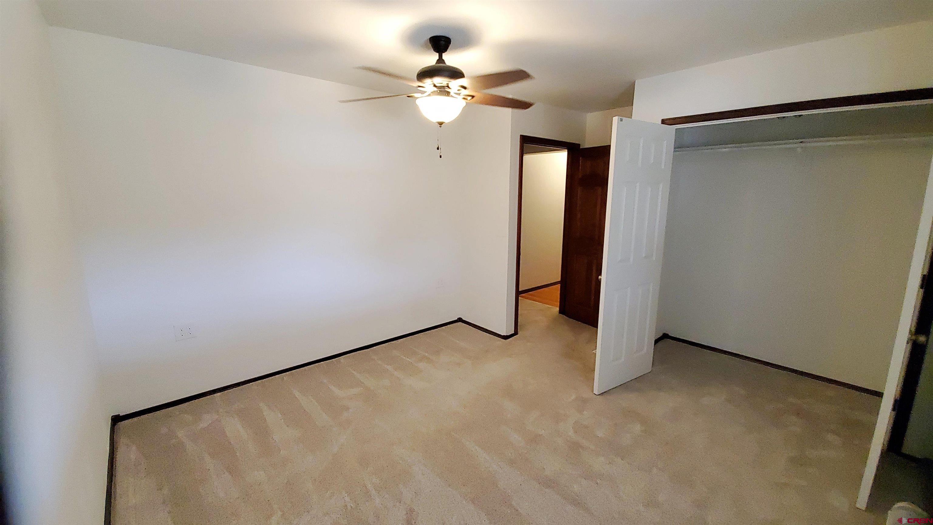 22250 County Rd M Cortez, CO 81321 - Photo 23 of 45 a view of a big room with closet and a chandelier fan