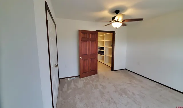 a view of room with window and ceiling fan