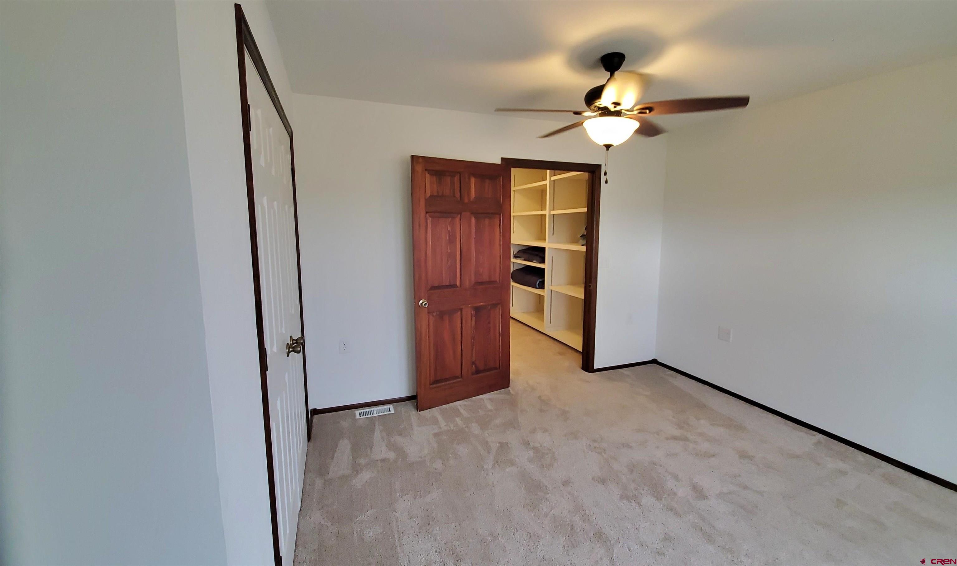 22250 County Rd M Cortez, CO 81321 - Photo 24 of 45 an empty room with closet and a chandelier fan