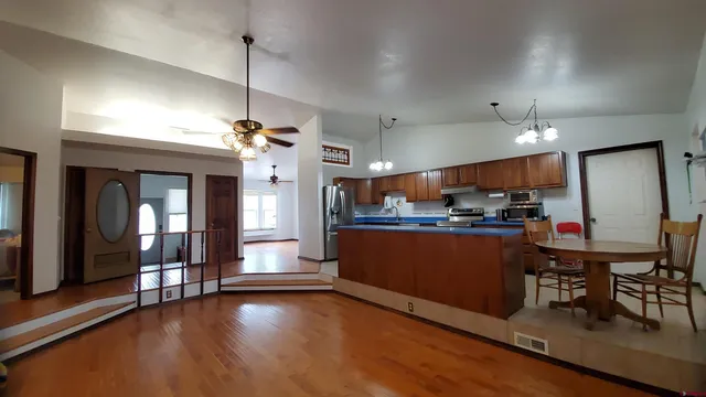 a view of a dining room with furniture wooden floor and chandelier