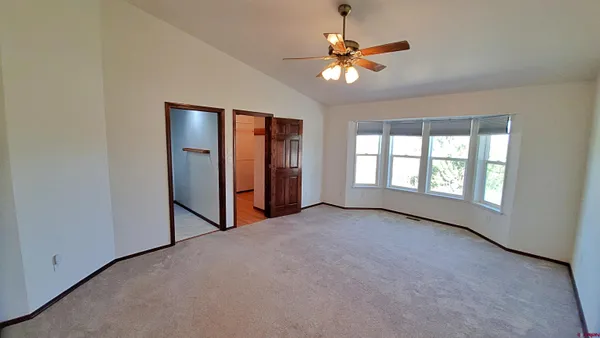 a view of room with window and ceiling fan