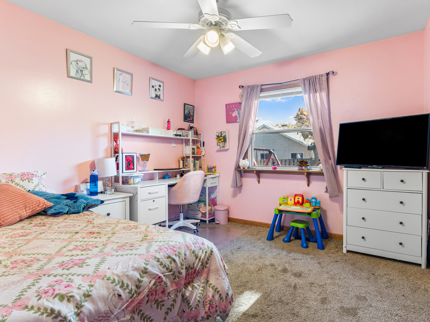 215 Fernwood Road Montgomery, IL 60538 - Photo 12 of 28 a bedroom with furniture and a flat screen tv
