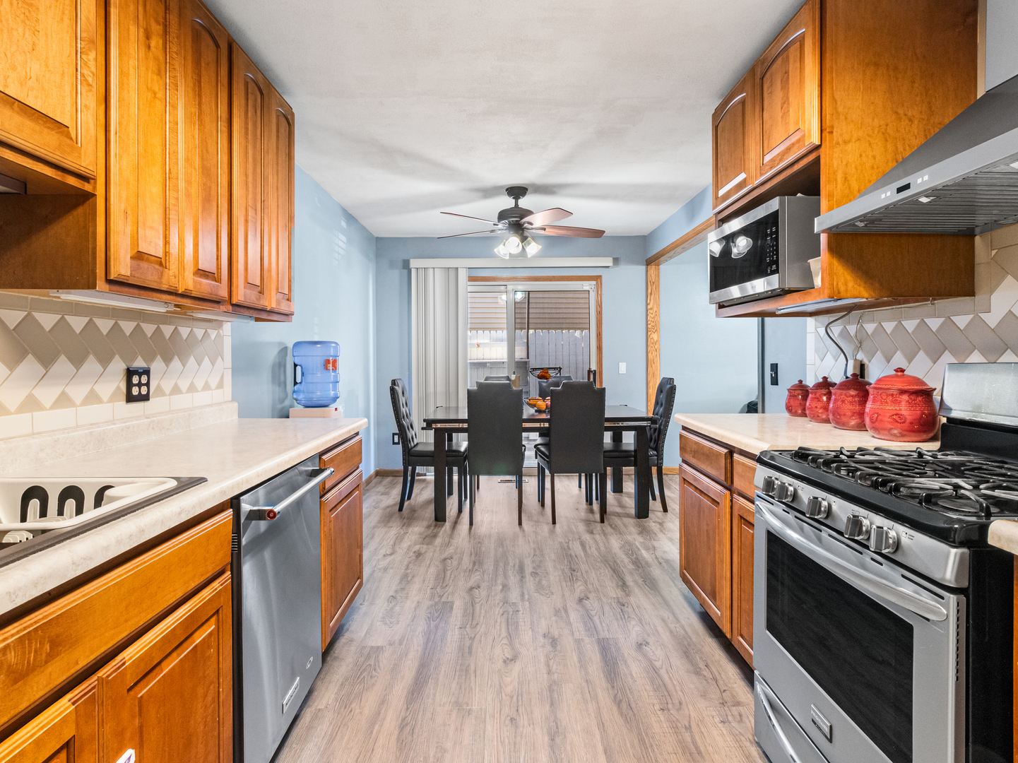 215 Fernwood Road Montgomery, IL 60538 - Photo 4 of 28 a kitchen with stainless steel appliances granite countertop a stove and a wooden floors