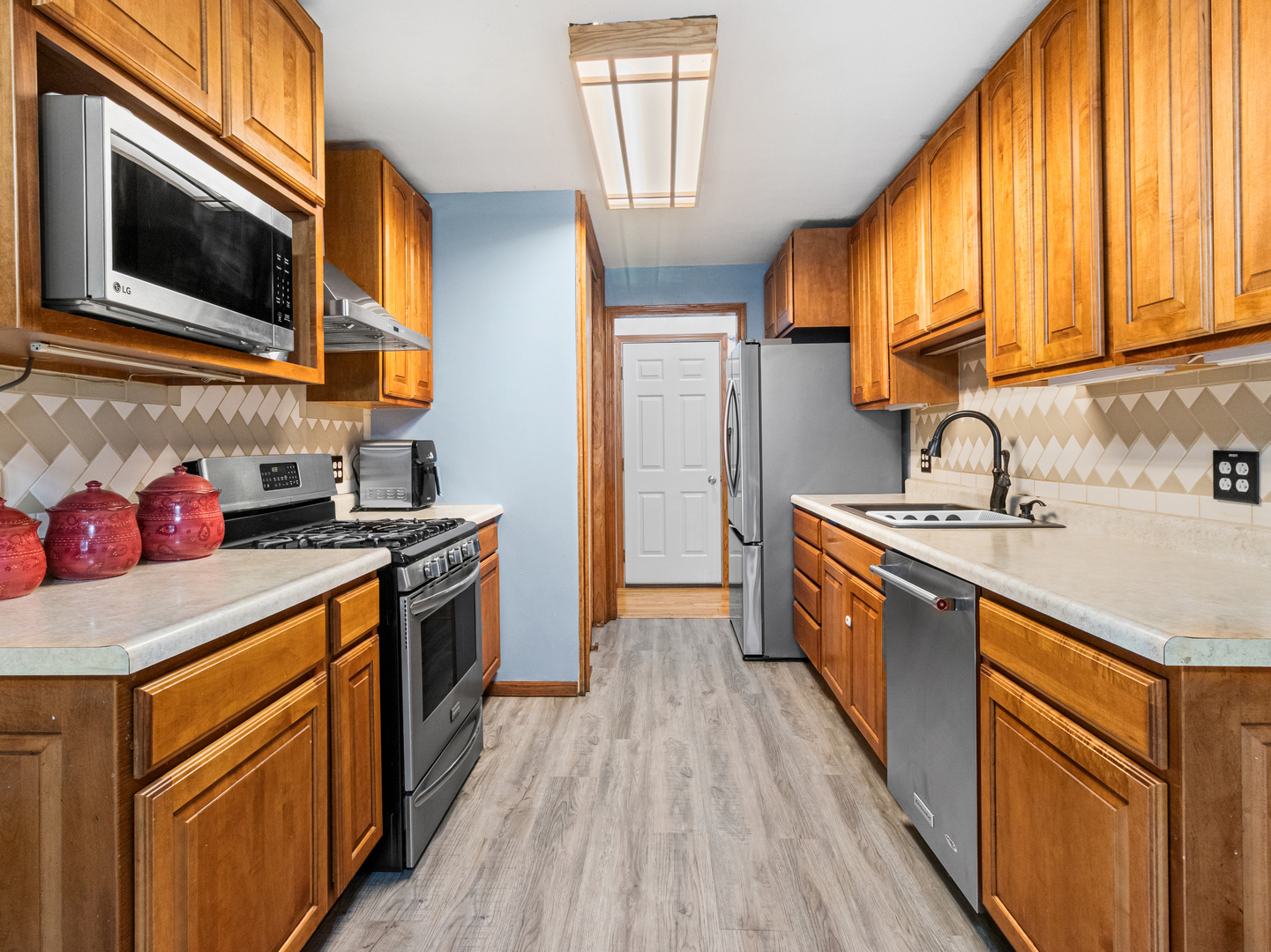 215 Fernwood Road Montgomery, IL 60538 - Photo 5 of 28 a kitchen with stainless steel appliances granite countertop a sink a stove wooden cabinets and a window
