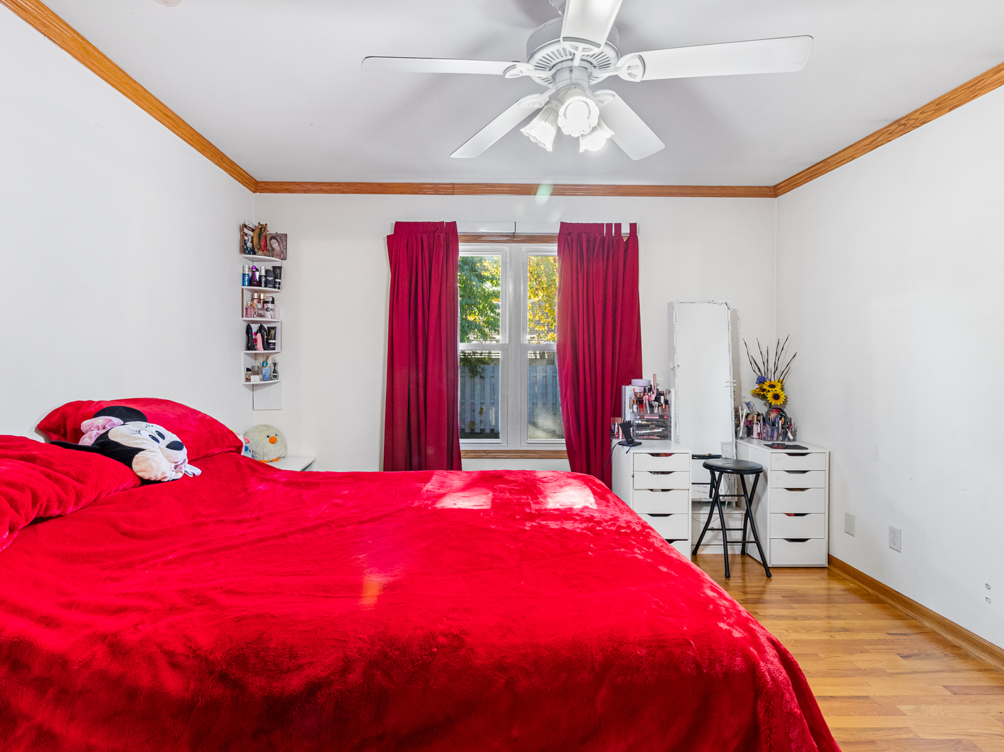 215 Fernwood Road Montgomery, IL 60538 - Photo 9 of 28 a bedroom with a bed and a chandelier