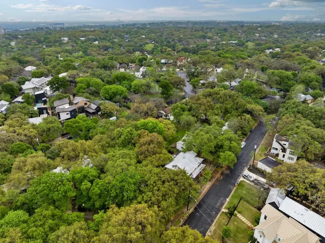 an aerial view of a house with a yard and lake view