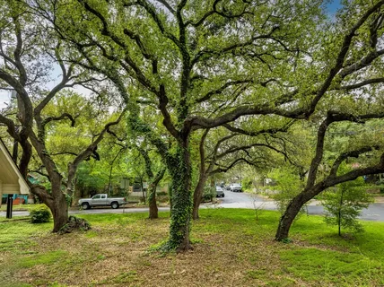 a view of a wooden dinning table and chairs in the garden
