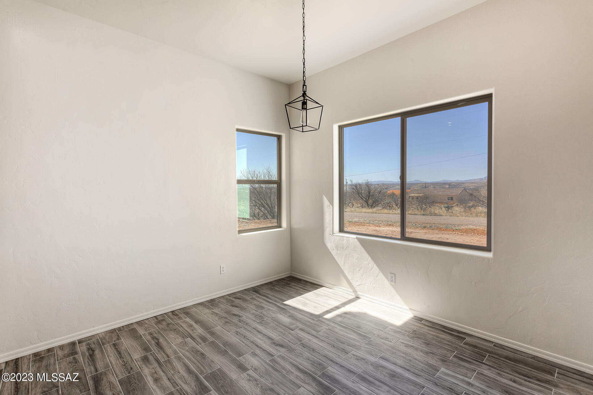 1813 Cajeme Court Rio Rico, AZ 85648 - Photo 10 of 15 a view of empty room with wooden floor and fan
