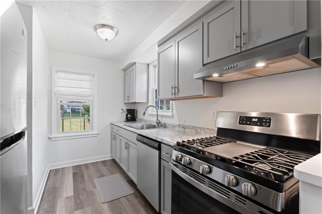 21 Circle Drive Beaver, PA 15009 - Photo 18 of 30 a kitchen with granite countertop a stove and a sink