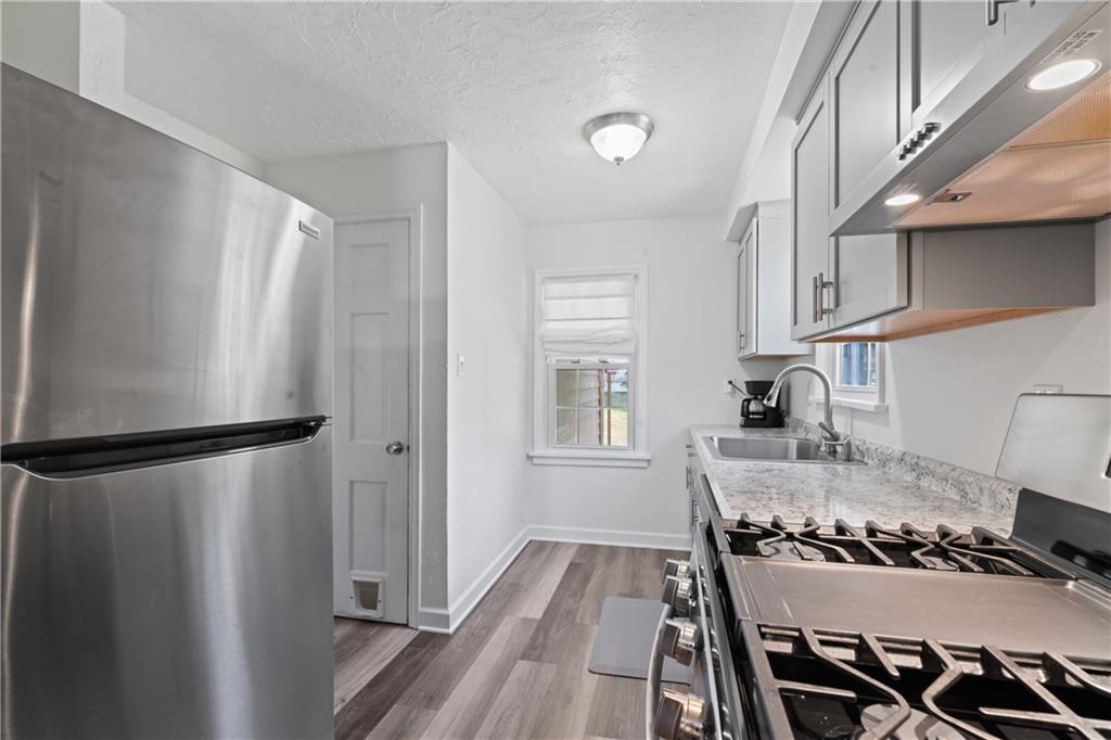 21 Circle Drive Beaver, PA 15009 - Photo 19 of 30 a kitchen with a refrigerator and a stove top oven