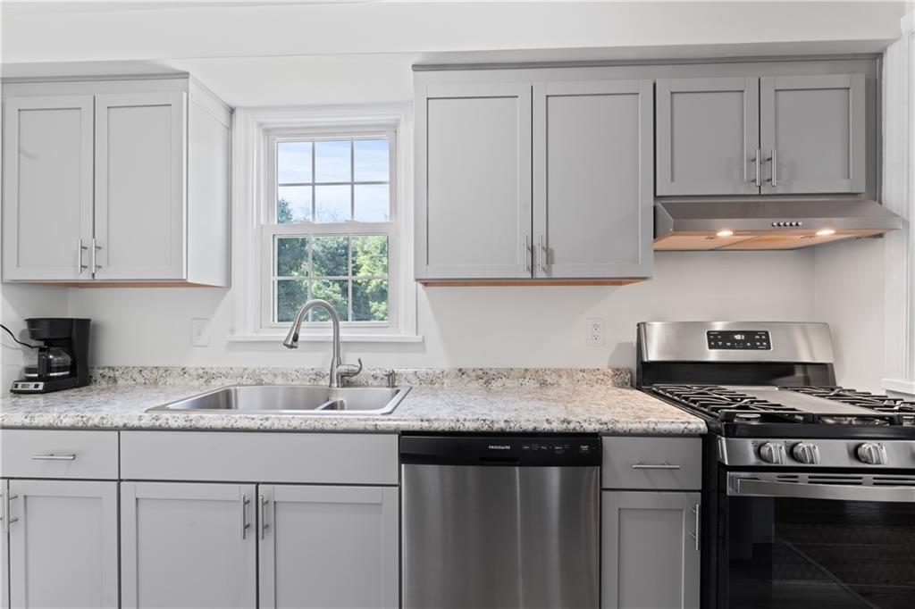 21 Circle Drive Beaver, PA 15009 - Photo 21 of 30 a kitchen with granite countertop a sink a stove and cabinets