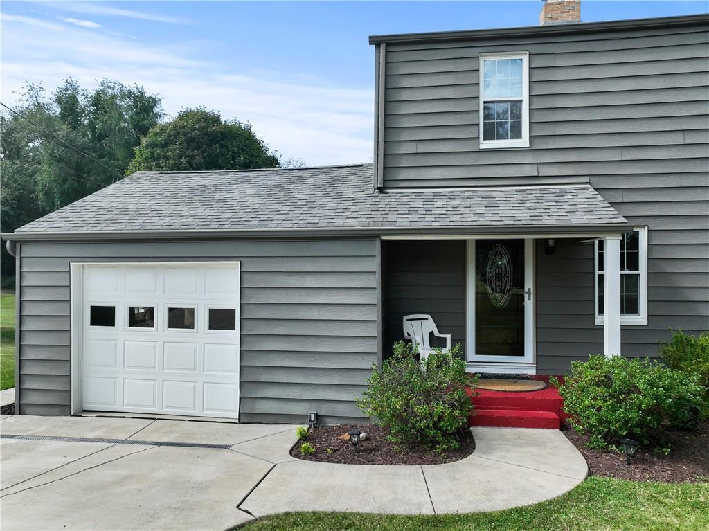 21 Circle Drive Beaver, PA 15009 - Photo 3 of 30 a view of a white house with large windows and flower plants