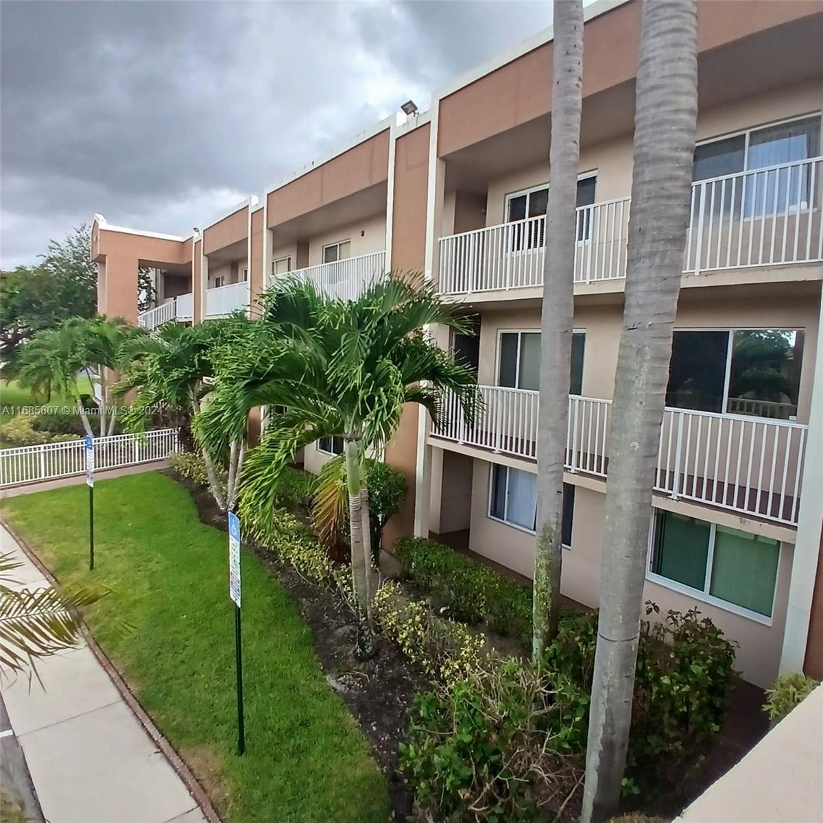 7136 South Devon Drive, Unit 207 Tamarac, FL 33321 - Photo 1 of 24 a front view of a house with a yard