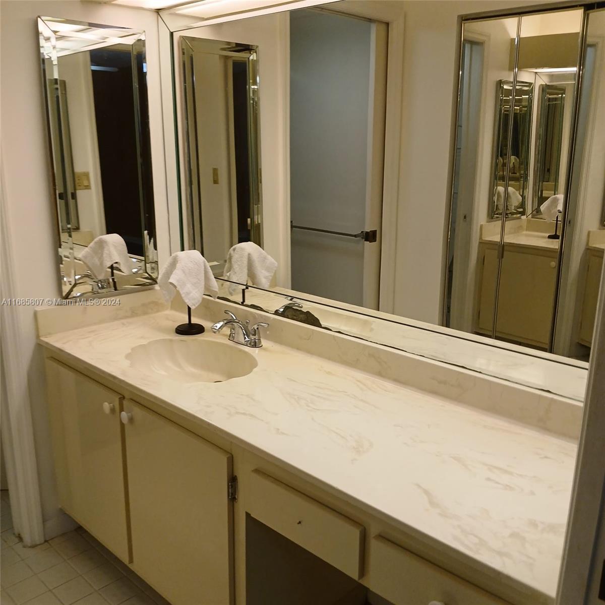 7136 South Devon Drive, Unit 207 Tamarac, FL 33321 - Photo 17 of 24 a bathroom with a sink and a mirror